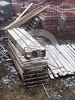 Construction material on building site during snowfall