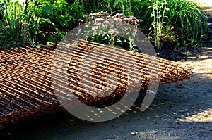 Construction material folded on a pallet on a pile. steel grilles are used as reinforcing bars. Nets can be used as a fence fillin
