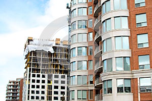 Construction and modern condo buildings with huge windows and balconies in Montreal