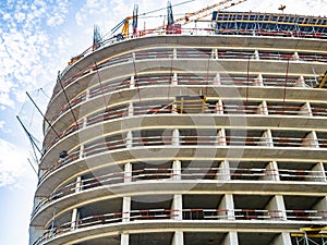 Construction of a modern high-rise building. Sides on the floors. Concrete frame of a building under construction. Construction