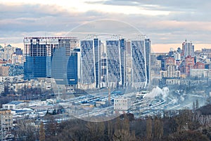 Construction of modern skyscrapers among residential areas of the city
