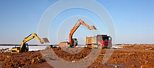 Construction of moorings for the parking of boats - excavators behind and dump truck work