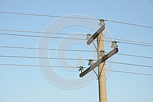 Construction for mounting a overhead power lines on top of column against blue sky