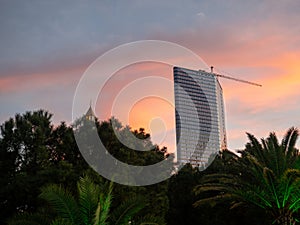 Construction of a multi-storey building against the backdrop of the sunset sky. Construction at the resort. Landscapes of Batumi.