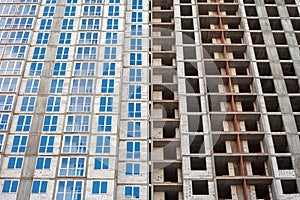 The construction of a multi-storey building in the city. one house at different stages
