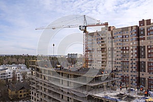 Construction of a multi-storey building, a crane at a construction site