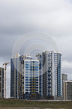 Construction of multi-storey buildings. Modern multi-storey building. Completed and under construction buildings. Construction