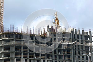 Construction of multi-storey buildings. Modern multi-storey building. Houses with reinforced concrete frame. Work construction