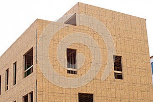 Construction of a new apartment building with the walls framed and covered with plywood modern