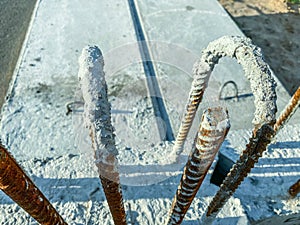 Construction of a new area of the city. in a concrete block rusty rebar painted with gray paint