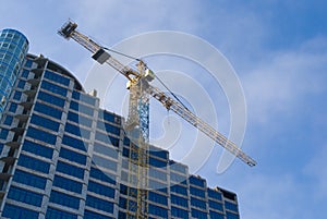 Construction - new blue glass building and crane