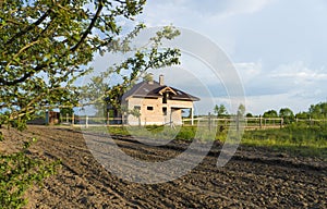 Construction of new brick family house in suburbs. Shell of town home with completed walls and roof. Building a home