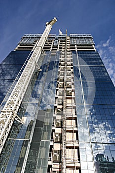 Construction of a new glass and steel skyscraper reflecting the perfect sky