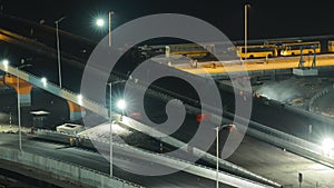 Construction Of New Highway Is Underway In Night Time. Workers Install Road Barriers. Men At Work. Construction Of New