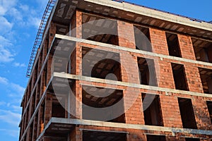 Construction of a new house of bricks. High rise construction.