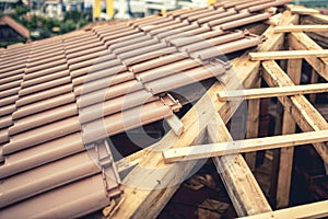 Construction of new house, roof building with brown tiles and timber. Contractor building roof of new house