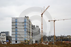 Construction of a new microdistrict with high houses, new buildings with developed infrastructure with the help of large