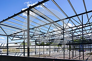 Construction of a new modern industrial building, metal truss frame