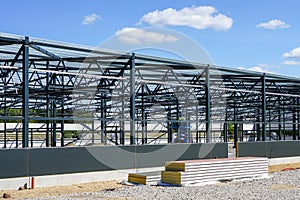 Construction of a new modern industrial building, metal truss frame