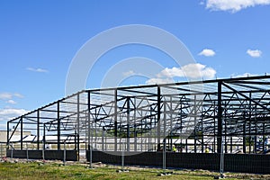 Construction of a new modern industrial building, metal truss frame