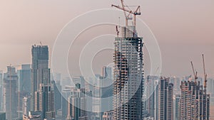 Construction of new modern skyscraper in Dubai city aerial timelapse, United Arab Emirates