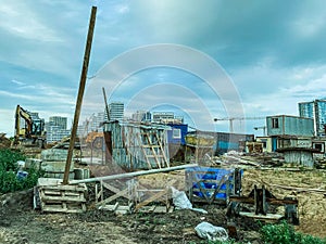 Construction of a new neighborhood. garbage on the site, wooden ruined houses for the life of builders. beautification of the new