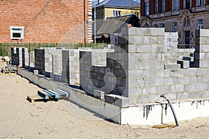 Construction of a new residential house from building blocks, insulation of foundations