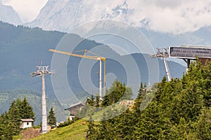 Construction of a new ski lift. Upper ski lift station. Yellow crane at the construction site