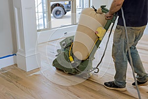 During the construction of a newly constructed house, you will find that a floor sander is being used to grind down a