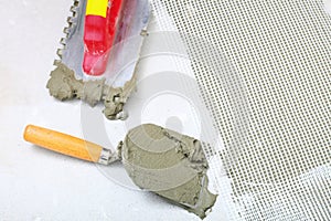 Construction notched trowel with mortar for tiles work