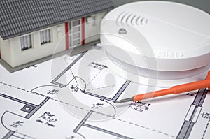 Smoke detector with a house and flames photo