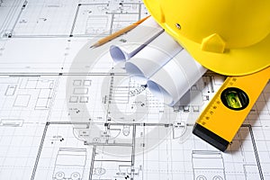 Construction plans with helmet and drawing tools on blueprints photo