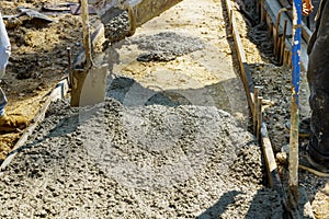 Construction process making of freshly poured cement new sidewalk in wet concrete