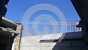 Construction in progress. Concrete wall and the crane