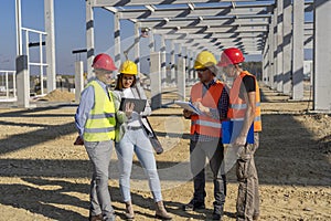 Construction Project Manager And His Team Discuss A Project On Construction Site