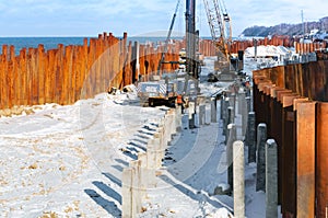 Construction of the promenade by the sea, construction equipment on the beach