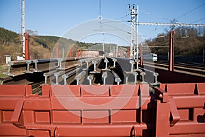 Construction of railway tracks. Railway infrastructure. Railroad car loaded with rails. Rails on a wagon ready for track