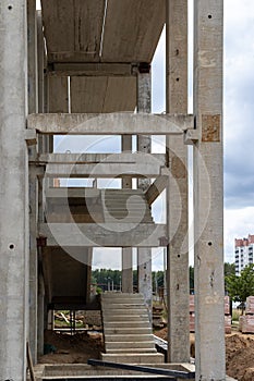 Construction of a reinforced concrete building. Elements of a concrete house. Structural elements. Construction site. Foundations