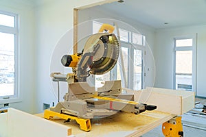 Construction remodeling home cutting wooden trim board on with circular saw