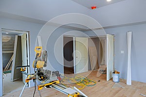 Construction remodeling home cutting wooden trim board on with circular saw