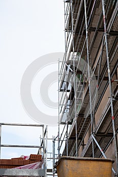 Construction and repair of the house.Scaffolding against a cloudy sky. Preparatory building work. Home construction