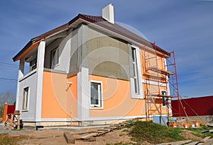 Construction or repair of the rural house with balcon, eaves, windows, chimney, roofing, fixing facade, insulation and painting photo