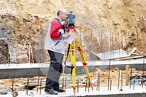 Construction of a residential area. Geodetic stakeout. Surveyor at a large construction site. A man with a tachometer during work