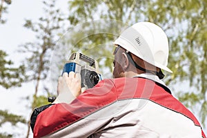 Construction of a residential area. Geodetic stakeout. Surveyor at a large construction site. A man with a tachometer during work