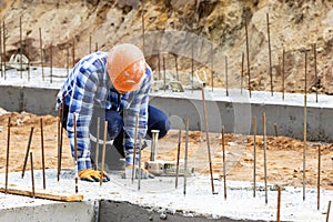 Construction of a residential area. Geodetic stakeout. Surveyor at a large construction site. A man with a tachometer during work photo