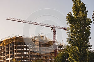 New flats, residential high-rise multistory house building. Construction crane.