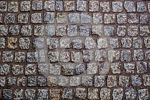 Construction of a road from a beautiful wet granite stone