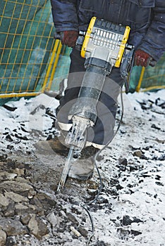 Construction road works with jack hammer