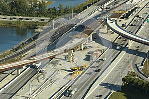 Construction roadworks on american transport infrastructure. Renovation of highway road interchange with moving traffic