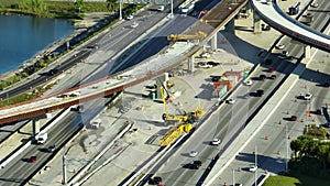 Construction roadworks on American transport infrastructure. Renovation of highway road interchange with traffic in